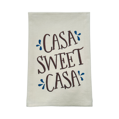 beige towel with the phrase Casa Sweet Casa in brown lettering with blue accents.