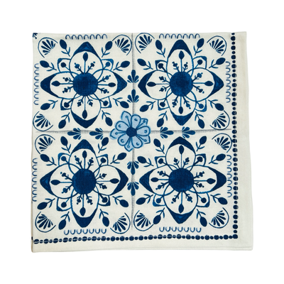 square napkin with a cream and blue Mediterranean design.