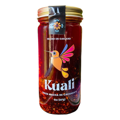 Front view of Kuali Salsa Macha de Cacahuate in clear glass branded jar with gold colored lid