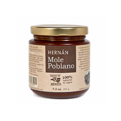 Front view of Hernán Mole Poblano in clear glass branded jar with gold colored lid