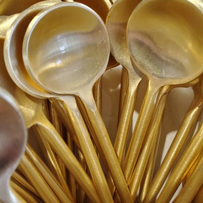 Collection photo for our "Shop By Color: Gold" collection. Image contains gold metal spoons