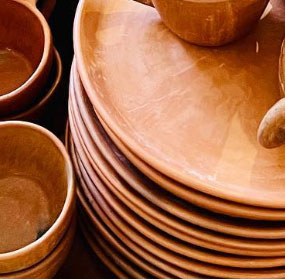 Collection photo for our "Shop By Color: Clay" collection. Image contains a stack of our terra cotta colored plates and bowls