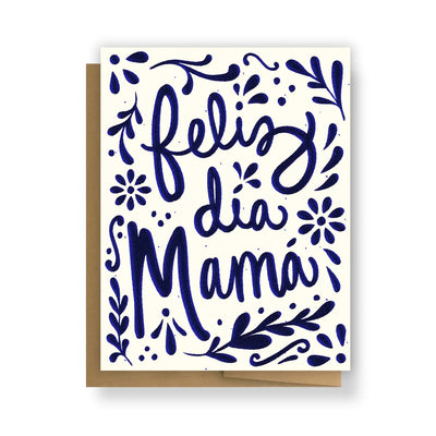 white card with blue foliage and flowers design featuring the phrase Feliz Dia Mama in blue lettering