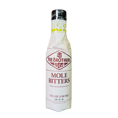 5 oz bottle of mole bitter with a branded beige label that wraps the whole bottle and features images of men on the top.