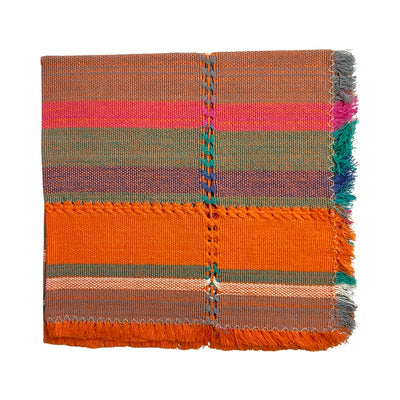 Handwoven napkin with stripes of orange, pink, bue, gray and natural colors folded in quarters