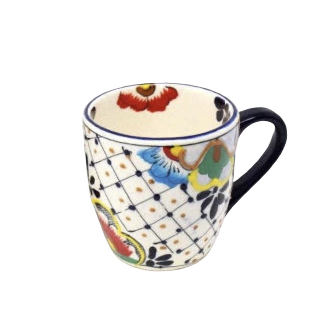 one ceramic mug that features the traditional Mexican talavera design with blues, yellows, reds and black.