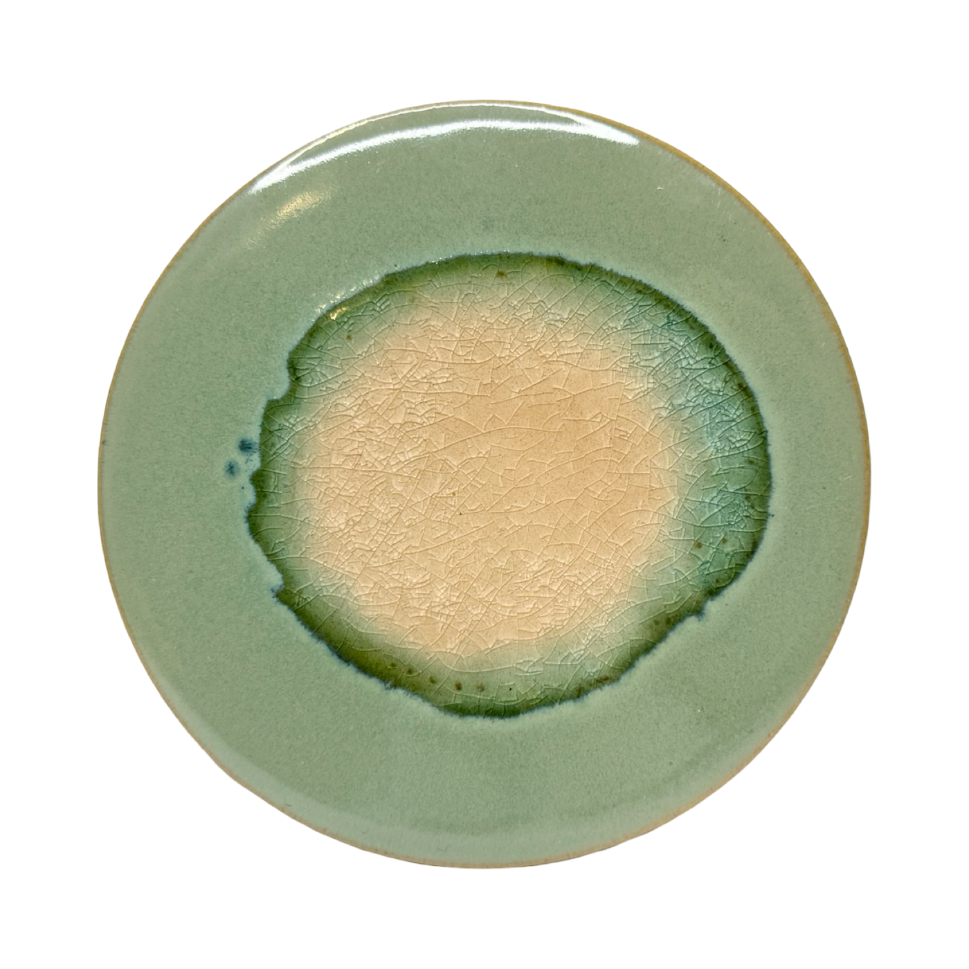 dark green round stoneware trivet with two-tone reactive glaze, showing slight variations in finish.