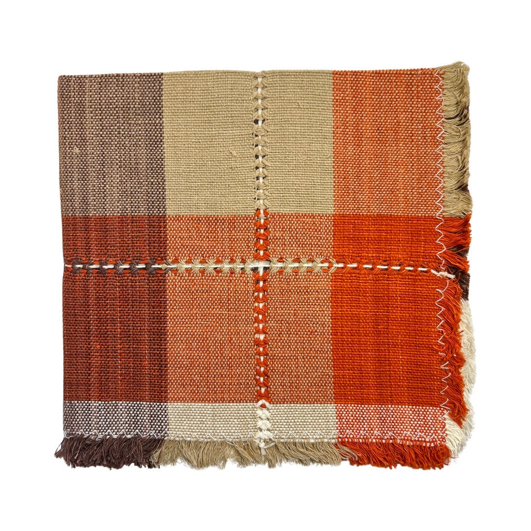 orange, brown, sienna striped handwoven napkin folded in quarters