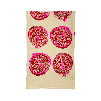 natural flour sack towel folded in quarters with a red and pink pomegranate pattern design