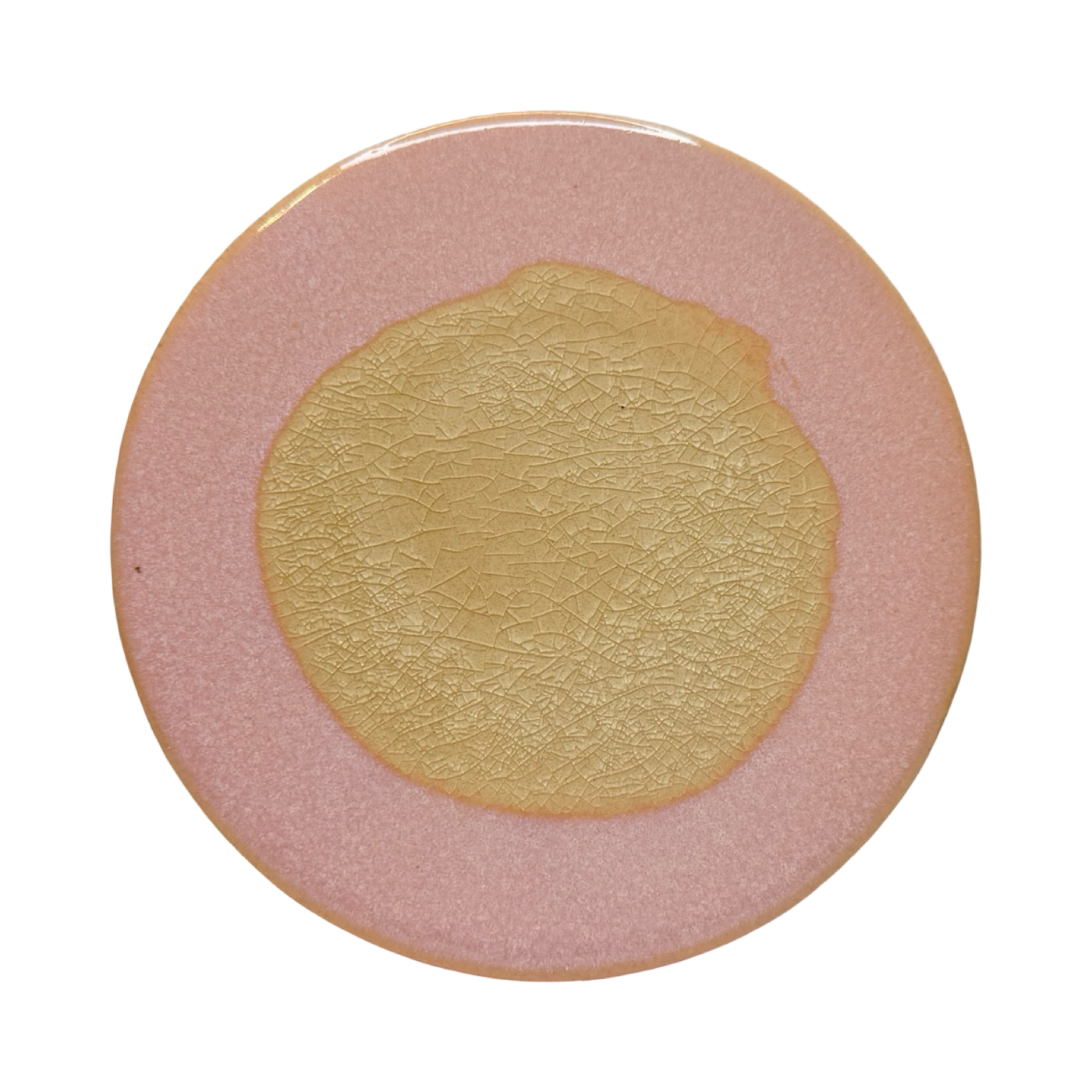 pink round stoneware trivet with two-tone reactive glaze, showing slight variations in finish.