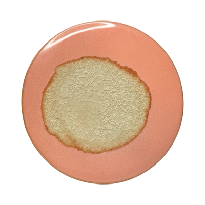 coral round stoneware trivet with two-tone reactive glaze, showing slight variations in finish.