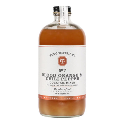 Clear glass bottle labeled “Yes Cocktail Co. No. 7 Blood Orange & Chili Pepper Cocktail Mixer, 16 fl oz,” filled with deep orange liquid.