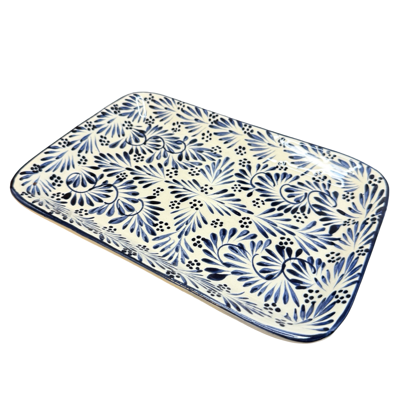 Rectangular ceramic serving platter hand-painted with blue plumeado feather-style designs on a cream background.
