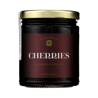 9 fl oz Dark glass jar with gold lid labeled “Yes Cocktail Co. Cherries — Bourbon Infused.