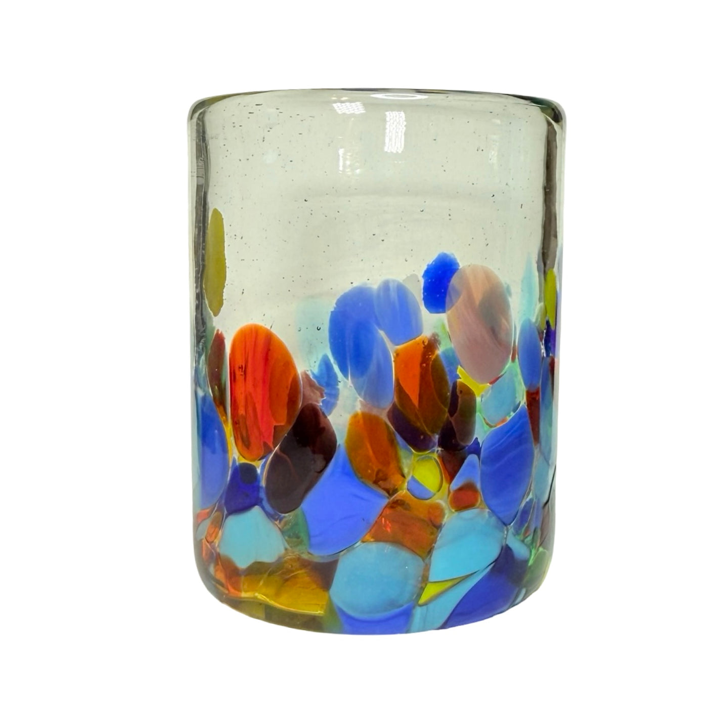 Clear handblown glass juice glass decorated with multicolored floral-like confetti patterns in red, yellow, blue, and green.