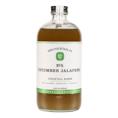 Clear bottle labeled “Yes Cocktail Co. No. 5 Cucumber Jalapeño Cocktail Mixer, 16 fl oz,” filled with light green-brown liquid.