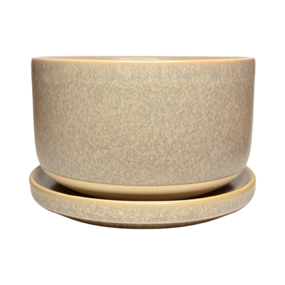 Light purple stoneware bowl with a speckled glaze, stacked on a matching plate with a smooth, matte finish.