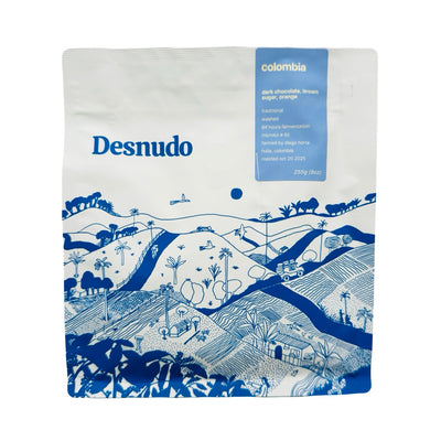 9 oz white Bag of Colombia Coffee featuring blue illustrated Colombian landscape.