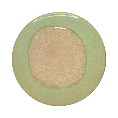 Light green round stoneware trivet with two-tone reactive glaze, showing slight variations in finish.