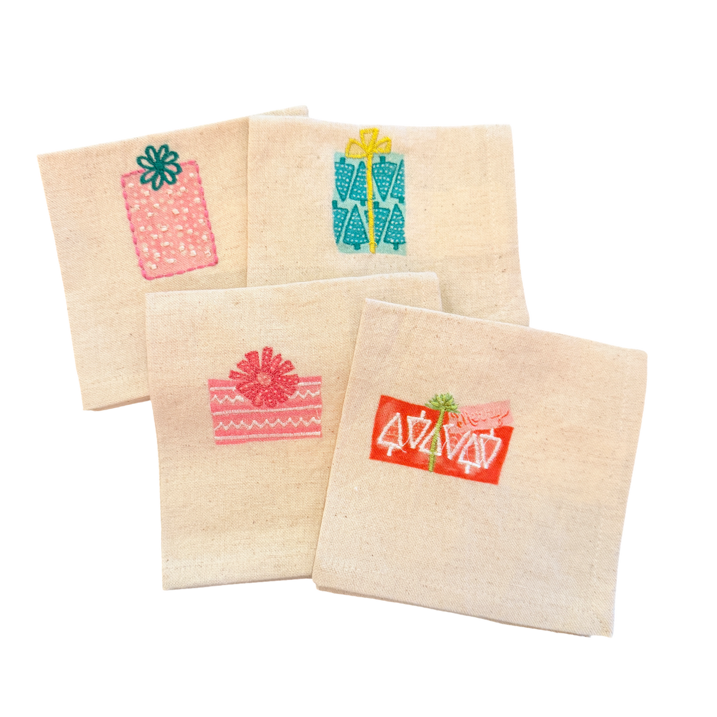 Set of four cotton cocktail napkins, each embroidered with a different colorful Christmas gift design.
