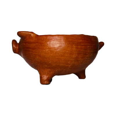 side view of a red clay pig bowl