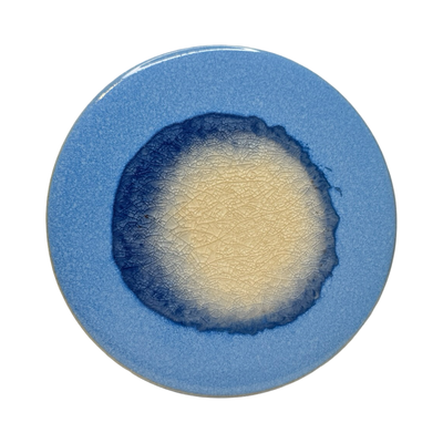 blue round stoneware trivet with two-tone reactive glaze, showing slight variations in finish.