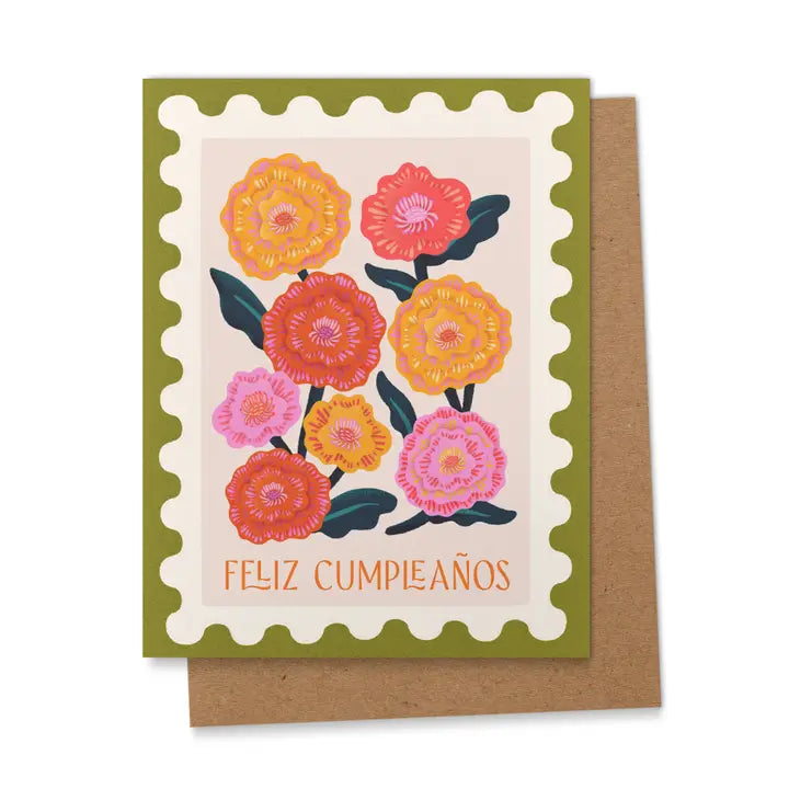 Greeting card with colorful marigold flowers and the words “Feliz Cumpleaños” in orange letters and a green border, as well as a kraft envelope.