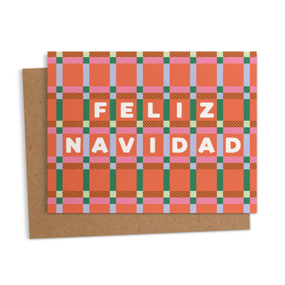 greeting card with a colorful plaid pattern in orange, pink, green, and blue, featuring the words “Feliz Navidad” in bold white letters.