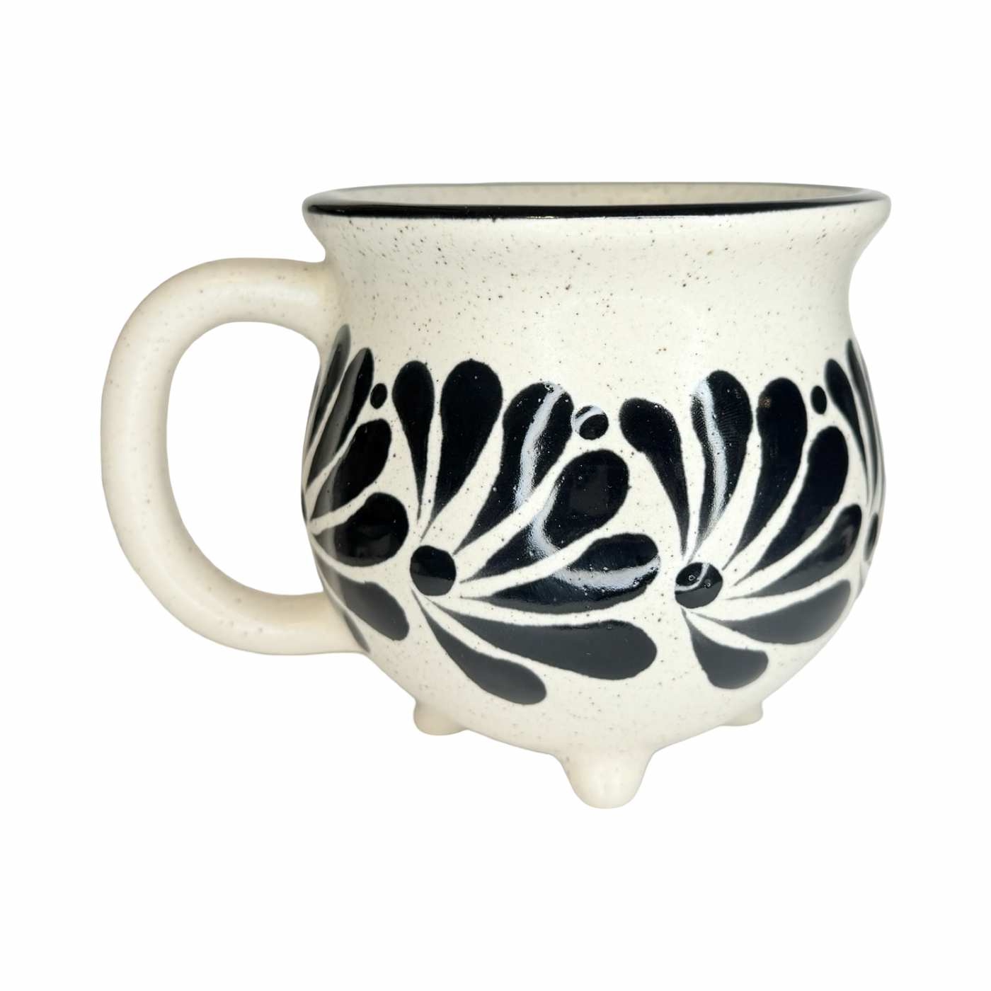 speckled cream ceramic perol mug with hand-painted black floral designs, rounded shape, and small feet at the base.