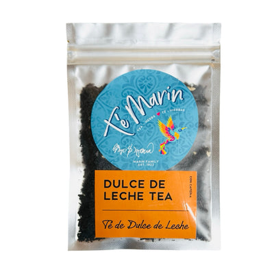 A clear resealable bag of loose leaf tea labeled “Te Marin.” The packaging features a blue circular logo with a colorful hummingbird and an orange label that reads “Dulce De Leche Tea.”