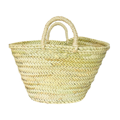 A handwoven straw market basket made from natural palm leaves, featuring a wide, open-top design and sturdy braided handles. 