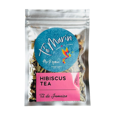 A clear resealable bag of loose leaf tea labeled “Te Marin.” The packaging features a blue circular logo with a colorful hummingbird and a pink label that reads “Hibiscus Tea.”