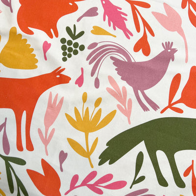 close up view of a orange, pink, light pink, sage green and yellow otomi design.