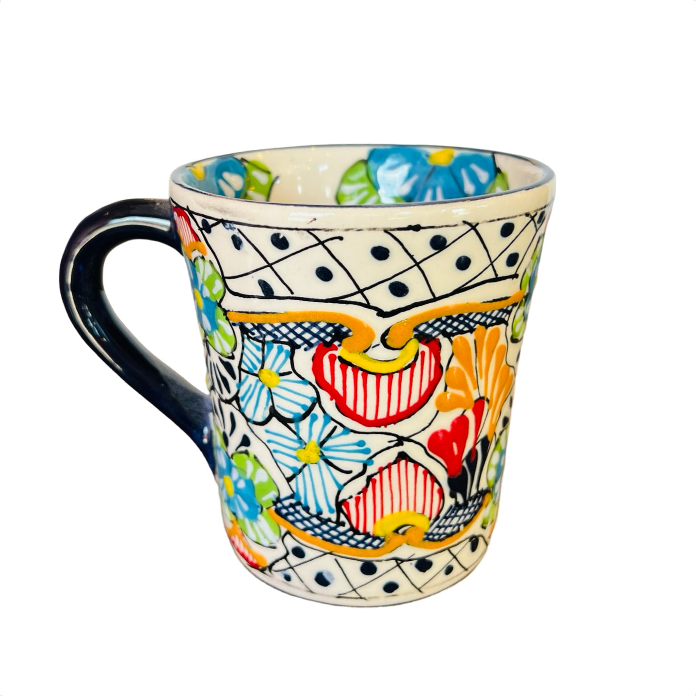 one ceramic mug that features the traditional Mexican talavera design with blues, yellows, reds and black.