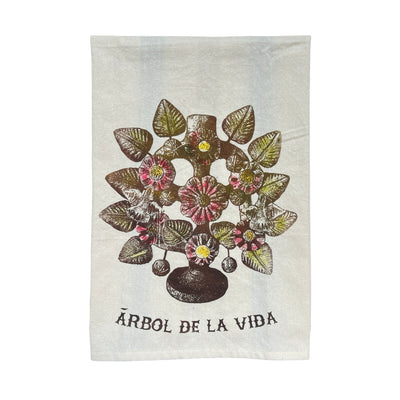 A quarter folded naturall kitchen towel featuring a Barro arbol de la vida, tree of life, sculpture in olive and green tones.