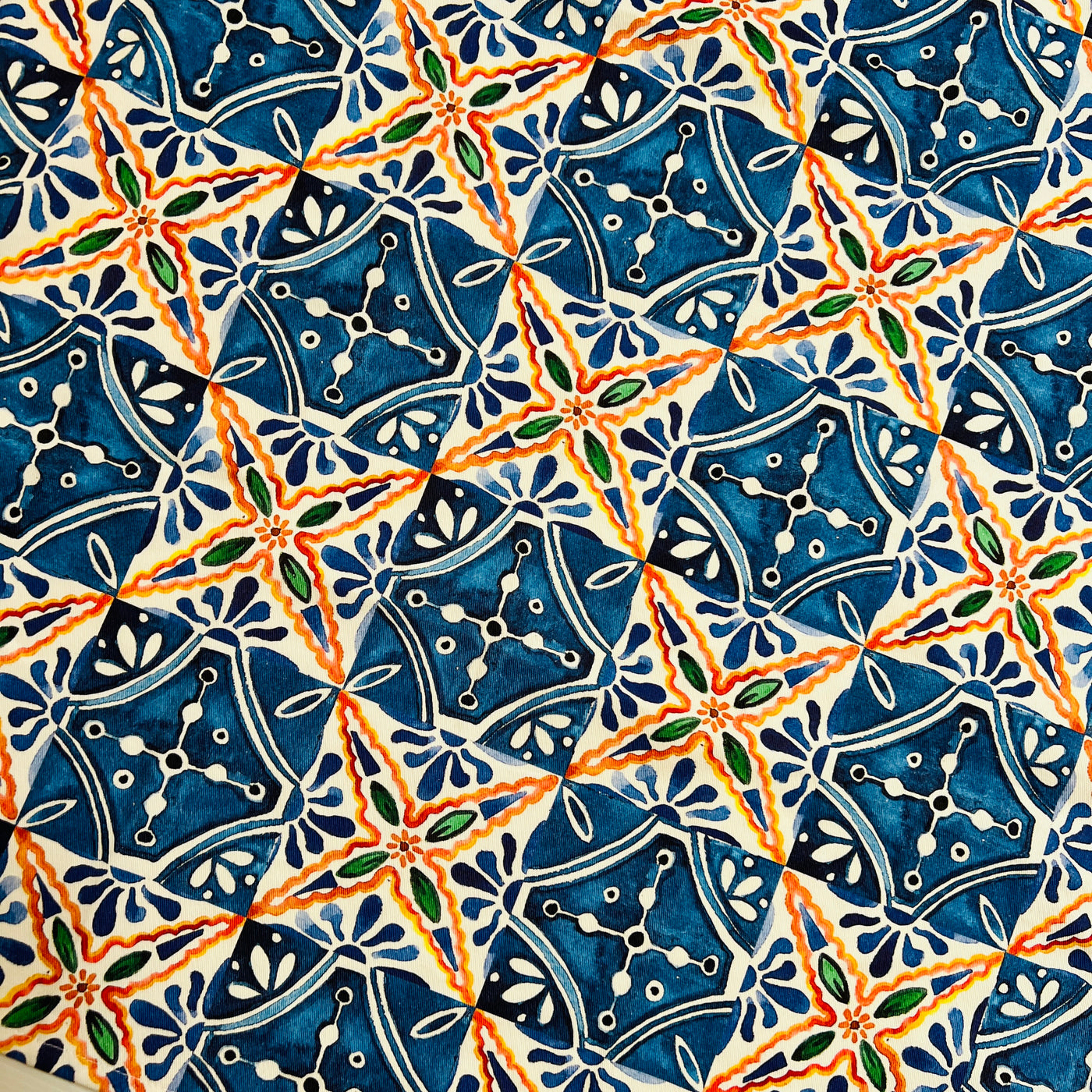 close up view of a Apron featuring a blue and orange Mexican tile design.