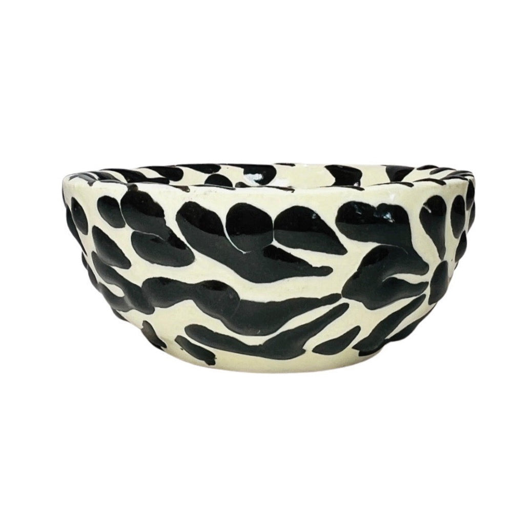 side view of a black and white Puebla design ceramic bowl