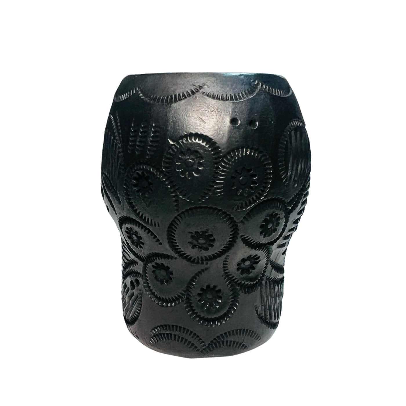 back  view of a black clay shot glass with a sugar and floral design.