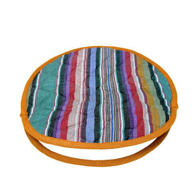 round tortilla warmer with a jewel-toned striped design and a gold colored trim.