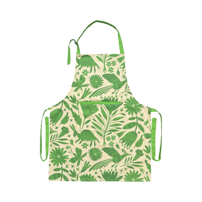 Cream apron with a green Otomi inspired design featuring green neck and waist ties. 