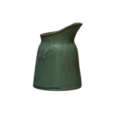 Green stoneware creamer with a speckled reactive glaze and smooth, curved spout, also suitable for use as a small vase.