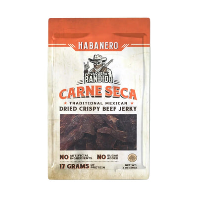 Front of Vaquero Bandido “Habanero Carne Seca” pouch with orange header and window showing dried beef; label reads “Traditional Mexican Dried Crispy Beef Jerky,” “No Artificial Ingredients,” “No Sugar Added,” “17 Grams of Protein,” net wt. 2 oz.