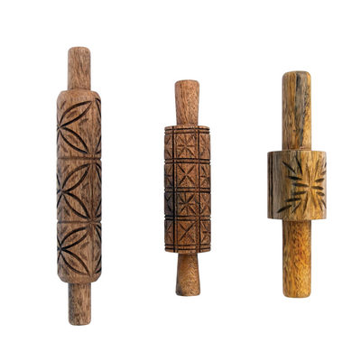 Set of three hand-carved mango wood rolling pins, each with a different geometric pattern and smooth wooden handles.