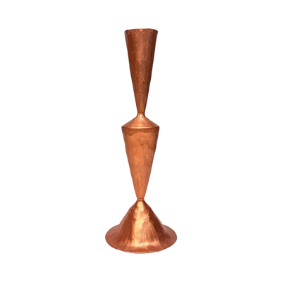 hand-forged cast iron taper candle holder with a smooth copper finish and modern sculptural shape.