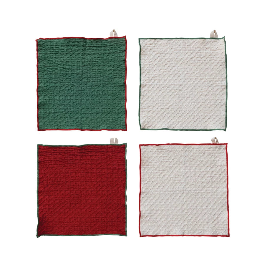 Square waffle-weave dish cloths in red, green, and ivory with contrasting trim and a small hanging loop at the top edge.