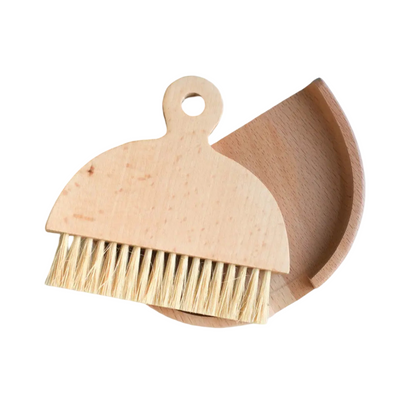 Small table brush with natural bristles and a matching curved pan that nest together for compact storage.