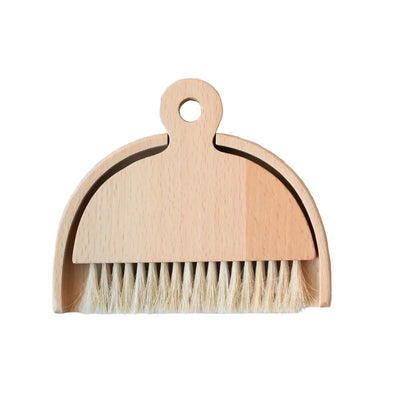 Small table brush with natural bristles and a matching curved pan that nest together for compact storage.