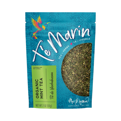 A teal resealable bag of Té Marín organic mint Tea with a clear window showing the loose herbal blend inside. The packaging features a colorful hummingbird and text in English and Spanish.