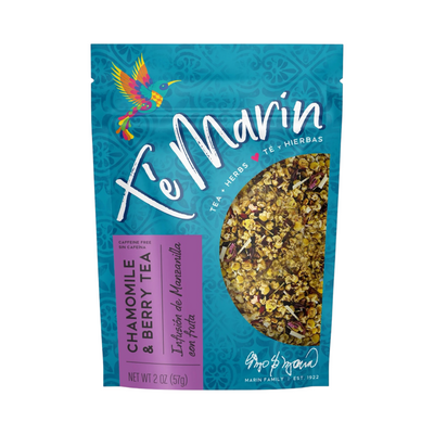 A 3 oz teal resealable bag of Té Marín Chamomile & Berry Tea with a clear window showing the loose herbal blend inside. The packaging features a colorful hummingbird and text in English and Spanish.