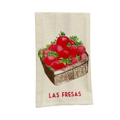 natural floursack towel folded in quarters with an image of a brown basket of red strawberries and the phrase Las Fresas in red lettering.